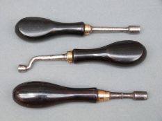 Three ebony handled nipple wrenches, one with crank shaft.