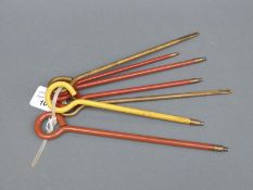 Seven various pistol cleaning rods