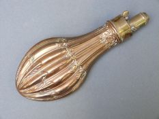 James Dixon & Sons copper and brass powder flask with embossed reeded decoration, 21cm long.