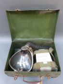 A cased gas mask dated 1973