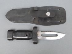 A naval diving knife in rubber sheath marked A.P.