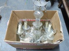 A glass chandelier with drop lustres