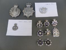 A collection of various police badges including Cornwall, Devon and Exeter helmet plate,