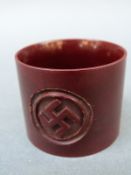 A Nazi German bakelite or similar napkin ring decorated with swastika