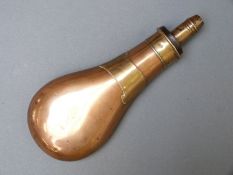 Sykes copper and brass powder flask with vacant scroll cartouche, 21cm long.
