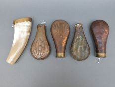 Four copper and brass powder flasks,