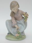 Lladro figurine of a girl with a basket of flowers