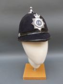 Three vintage police helmets including Devon and Cornwall