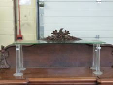 A glass two tier shop display interest shelf unit supported by eight octagonal cut glass columns