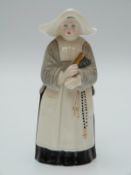 Royal Worcester candle snuffer in the form of a nun or abbess with puce mark.