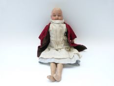 Goss bisque headed doll with closed mouth, fixed blue eyes, soft body and bisque limbs,