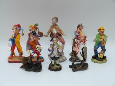 Six clown figures and two German porcelain figures