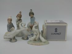 Eight Lladro and Nao figures including a child with a lamb