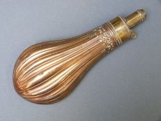 G & J.W. Hawksley copper and brass powder flask with embossed reeded decoration, 21cm long.