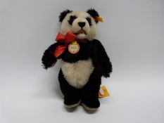 Steiff 1938 replica Panda teddy bear with jointed limbs, button and label to ear, pendant and label,