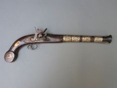 An Eastern flint lock hammer action pistol with silver wire and bone inlaid stock and 12inch flared