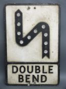 A vintage cast aluminium 'double bend' sign with honeycomb style reflectors,