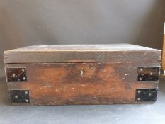 An antique oak travelling box with metal corner protectors