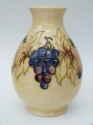 Moorcroft bulbous vase decorated with fruit on a yellow ground,