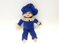 A bisque-headed doll with soft body, bisque limbs and rotating head, having three faces,