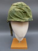Two American Vietnam era military helmets,
