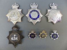 A collection of Metropolitan Police helmet plates and badges