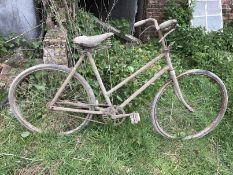 A vintage bicycle with sprung seat.
