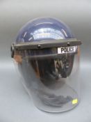Two British police riot helmets and a further example