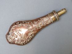 T Collins copper and brass powder flask with fine embossed decoration of deer in a field surrounded