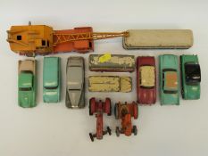 Twelve Dinky Toys diecast model vehicles including tractors, vans, buses,