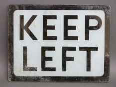 A glass 'keep left' sign,