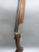 Browning Medallist 12 bore over and under shotgun with named and ornately engraved locks,