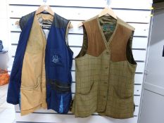 Two gentleman's shooting coats comprising a Musto navy jacket and a Bronte tweed example,