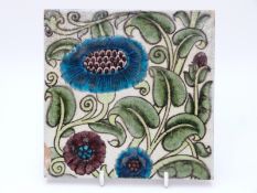 William de Morgan tile with floral decoration on a white ground, maker's mark to back (15.