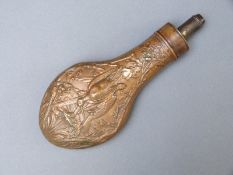 Copper and brass powder flask with heavily embossed decoration of game birds to one side and leaves