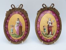 A pair of porcelain plaques in ormolu style frames (19cm tall)