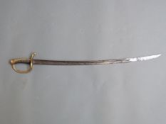 A 19th century continental cavalry sword with ornate brass and wooden handle and decorative etched