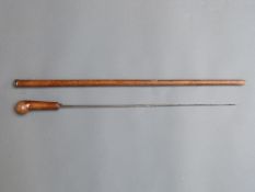 A hardwood sword stick with 56cm tapering double edged blade and white metal collar,