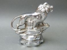 A large vintage car mascot modelled as a lion on a rocky outcrop on radiation cap, 15.