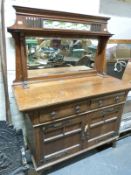 An oak Arts and Crafts style dresser with tile insert, bevelled glass mirror,