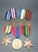 A collection of WWII medals including 1939-45 India medal, Pacific, Burma, Atlantic,