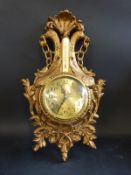 An ornate clock barometer