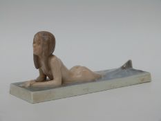 A Royal Copenhagen model of a mermaid numbered 1212 to underside (length 20cm)