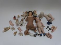 Fourteen bisque and porcelain dolls and dolls' heads including miniature examples