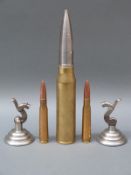 Five novelty paperweights one in the form of a 30mm cannon shell,