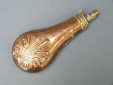 James Dixon & Sons copper and brass powder flask with embossed decoration, 20cm long.