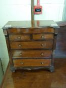 A Victorian serpentine fronted mahogany apprentice or miniature chest of two over three drawers