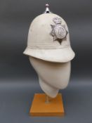 A vintage white Brighton police helmet