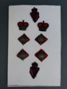 A set of Irish police metal badges and insignia with pierced harp and shamrock decoration