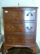 A bow fronted chest of three drawers (H70 x W52 x D42cm)